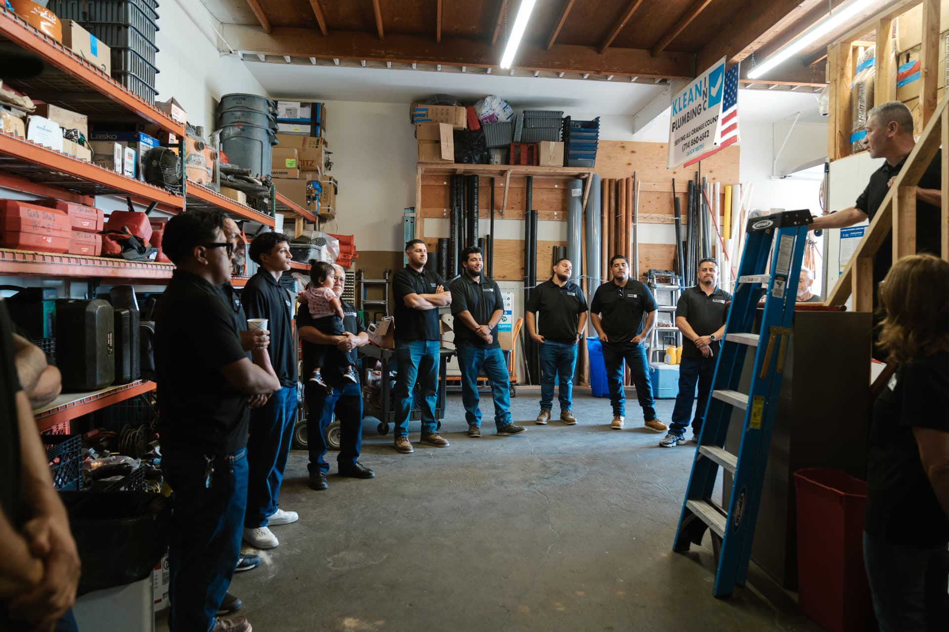 The crew gathered for a morning meeting in the Klean Plumbing shop