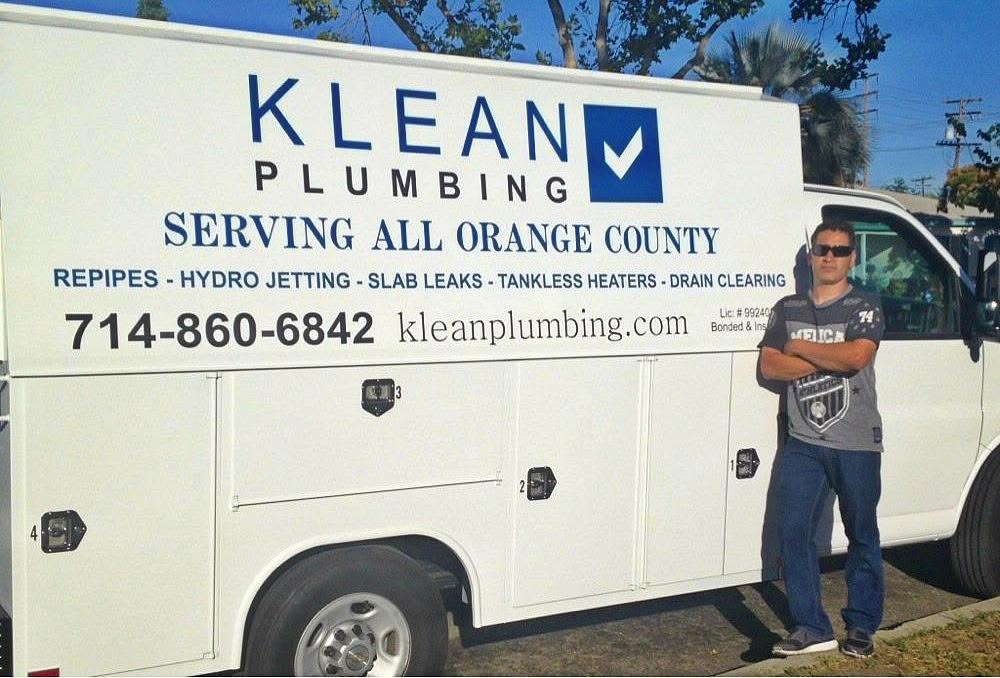 Klean Plumbing owner standing beside a company service van in the early years